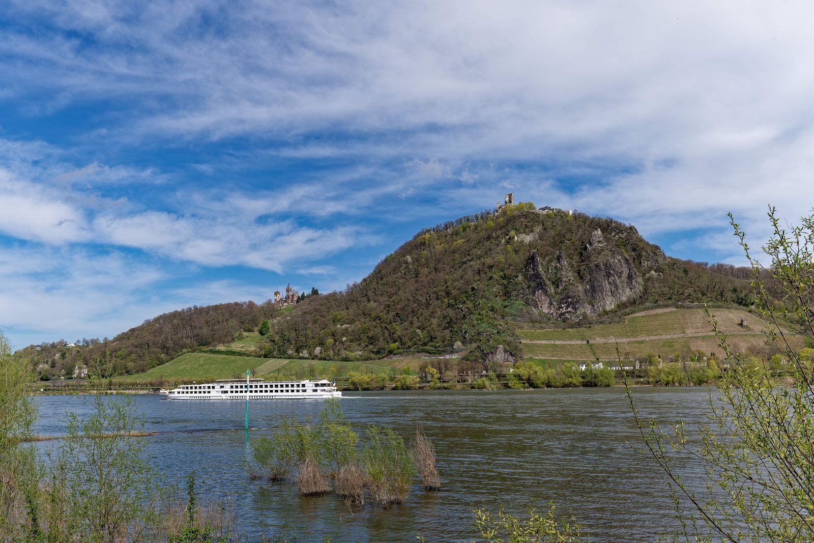 River cruise ship passing below the Drachenfels on the Rhine, a route sailed by many luxury river cruise lines